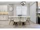 Bright dining area featuring a white table and chairs, designer light fixture and decor at 13320 Magnolia Valley Dr, Clermont, FL 34711