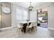 Bright dining area featuring modern white table and chairs, stylish lighting and sliding glass doors at 13320 Magnolia Valley Dr, Clermont, FL 34711