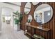 Inviting entryway with stylish wood accent wall and console table with decor and tile flooring at 13320 Magnolia Valley Dr, Clermont, FL 34711