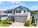 Elegant two-story home with a two-car garage, manicured lawn and front yard landscaping at 13320 Magnolia Valley Dr, Clermont, FL 34711