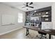 Stylish home office features a dark accent wall with shelving and a large white board for a great workspace at 13320 Magnolia Valley Dr, Clermont, FL 34711