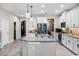 Open kitchen with a large island, stainless steel appliances and bright lighting at 13320 Magnolia Valley Dr, Clermont, FL 34711