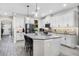 Bright kitchen features stainless appliances, a large island with seating, and stylish gray countertops at 13320 Magnolia Valley Dr, Clermont, FL 34711