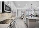 Modern kitchen featuring stainless steel appliances, gray countertops, and white cabinets and backsplash at 13320 Magnolia Valley Dr, Clermont, FL 34711