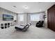 Loft area with comfortable seating, a large screen TV, and decorative accents at 13320 Magnolia Valley Dr, Clermont, FL 34711