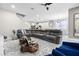 Spacious open-concept living room adjacent to kitchen with large sectional sofa at 13320 Magnolia Valley Dr, Clermont, FL 34711