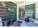Covered patio with mounted TV, seating and view of the home's interior at 13320 Magnolia Valley Dr, Clermont, FL 34711