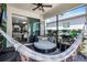 Relaxing screened-in patio with daybed, ceiling fan, and outdoor grilling station, perfect for summer entertaining at 13320 Magnolia Valley Dr, Clermont, FL 34711