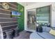Covered patio with mounted TV, seating and view of the home's interior at 13320 Magnolia Valley Dr, Clermont, FL 34711