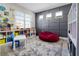 Well-organized playroom with shelving, a comfy beanbag, and decorative wall paneling at 13320 Magnolia Valley Dr, Clermont, FL 34711