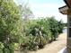 Backyard with lush tropical trees and a distant view of the water at 143 Villa Di Este Ter # 205, Lake Mary, FL 32746