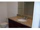 Bathroom vanity features granite countertop, dark wood cabinetry and a large mirror at 143 Villa Di Este Ter # 205, Lake Mary, FL 32746