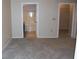 Carpeted bedroom with doorways to the bathroom and closet at 143 Villa Di Este Ter # 205, Lake Mary, FL 32746