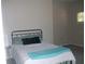 Comfortable bedroom with a metal bed frame, soft bedding, and natural light at 143 Villa Di Este Ter # 205, Lake Mary, FL 32746