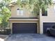 Two-story home with a two-car garage and a well-maintained lawn at 143 Villa Di Este Ter # 205, Lake Mary, FL 32746