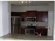 Modern kitchen featuring stainless steel appliances, granite countertops, and ample counter space at 143 Villa Di Este Ter # 205, Lake Mary, FL 32746
