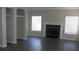 Comfortable living room featuring hardwood floors, a fireplace, and built-in shelving at 143 Villa Di Este Ter # 205, Lake Mary, FL 32746