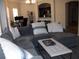Spacious living room with a large sectional sofa and comfortable seating area, perfect for relaxing and entertaining at 143 Villa Di Este Ter # 205, Lake Mary, FL 32746