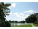 Scenic view of a tranquil pond with lush greenery, perfect for leisurely strolls at 143 Villa Di Este Ter # 205, Lake Mary, FL 32746