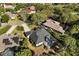 Aerial view of a home featuring a screened-in pool, and lush landscaping in a residential neighborhood at 14378 Stamford Cir, Orlando, FL 32826