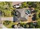 Aerial view showcasing the roofline, pool, backyard, driveway, and surrounding landscaping of the home at 14378 Stamford Cir, Orlando, FL 32826