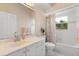 Cozy bathroom with a single vanity, toilet, and shower-tub combo with a decorative shower curtain at 14378 Stamford Cir, Orlando, FL 32826