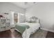Bright bedroom features a bed with a gray upholstered headboard, white bedding, and a large window at 14378 Stamford Cir, Orlando, FL 32826