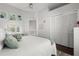 Bright bedroom with a light vanity, closet with louvered doors, and a bed with plush pillows at 14378 Stamford Cir, Orlando, FL 32826