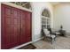 Inviting entryway with double doors, tiled floor, sitting area, and lots of natural light at 14378 Stamford Cir, Orlando, FL 32826