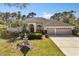 Charming single-story home with a well-manicured lawn, beautiful landscaping, and a circular driveway at 14378 Stamford Cir, Orlando, FL 32826