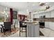 Modern kitchen with a breakfast bar, stainless steel appliances, and views into the living room at 14378 Stamford Cir, Orlando, FL 32826