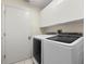 Convenient laundry room with a side-by-side washer and dryer and upper cabinets for ample storage at 14378 Stamford Cir, Orlando, FL 32826