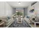 Bright living room with a piano, comfortable seating, and a view of the backyard at 14378 Stamford Cir, Orlando, FL 32826