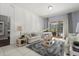 Bright living room with a piano, comfortable seating, and a view of the backyard at 14378 Stamford Cir, Orlando, FL 32826