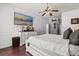 Main bedroom with a large TV, modern decor, and en-suite bathroom access at 14378 Stamford Cir, Orlando, FL 32826