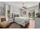 Bright main bedroom featuring a plush bed, modern decor, and sliding glass doors to the pool at 14378 Stamford Cir, Orlando, FL 32826