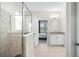Neutral bathroom featuring a granite counter, glass shower, and an open door to the bedroom at 1540 Softshell St, St Cloud, FL 34771
