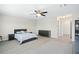 Large bedroom with a ceiling fan, light walls, and sleek gray floors at 1540 Softshell St, St Cloud, FL 34771