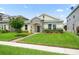 Charming single-story home with stone accents, a well-manicured lawn, and tidy landscaping at 1540 Softshell St, St Cloud, FL 34771