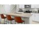Open kitchen featuring granite countertops, stainless steel appliances and bar stool seating at the island at 1540 Softshell St, St Cloud, FL 34771