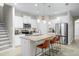 Bright kitchen with white cabinets, stainless steel appliances, granite countertops, and bar stool seating at 1540 Softshell St, St Cloud, FL 34771