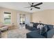 Cozy living room with a plush sectional sofa, neutral walls, and sliding glass doors to the patio at 1540 Softshell St, St Cloud, FL 34771