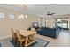 Open living space featuring a dining table, comfortable sofa, and sliding glass doors for natural light at 1540 Softshell St, St Cloud, FL 34771
