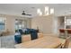 Open-concept living space featuring a modern chandelier, comfortable sofa, and kitchen with bar stool seating at 1540 Softshell St, St Cloud, FL 34771