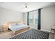 Calm main bedroom with wood-look floors, neutral walls, and windows providing natural light at 1540 Softshell St, St Cloud, FL 34771
