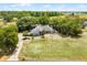 Aerial view of a charming home with lush trees and a long drive way at 1689 Saboff Way, Chuluota, FL 32766