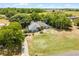 Aerial view of a single story home nestled in a private wooded setting with mature landscaping at 1689 Saboff Way, Chuluota, FL 32766