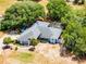 Aerial view showcasing a sprawling property with mature trees, a charming home, and a screened in pool at 1689 Saboff Way, Chuluota, FL 32766