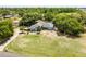 Aerial view of a charming home with lush trees and a long driveway at 1689 Saboff Way, Chuluota, FL 32766