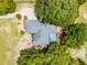 Aerial view of the property showcasing the house, screened-in pool, driveway, and surrounding trees at 1689 Saboff Way, Chuluota, FL 32766